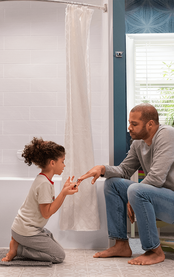 Father and Daughter Painting Fingernails in the Bathroom