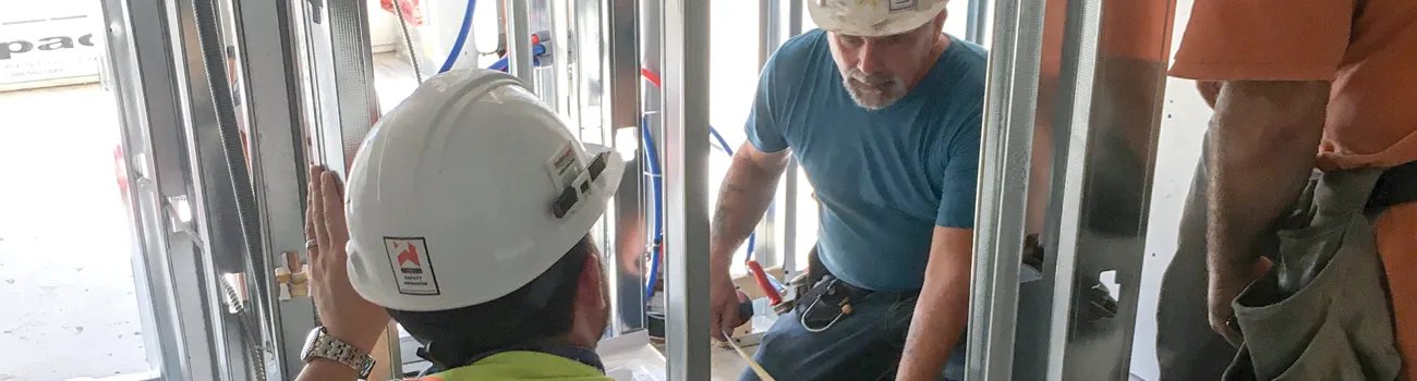 Construction Workers Installing Bathroom Plumbing