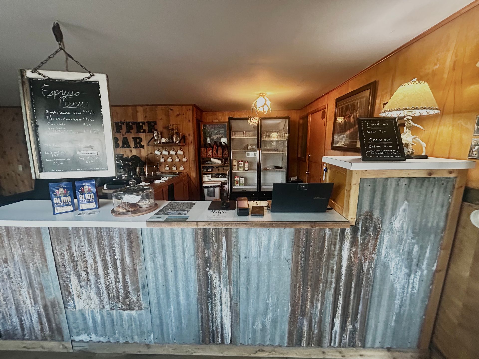 Coffee bar with corrugated metal counter, menu board, and espresso machine.