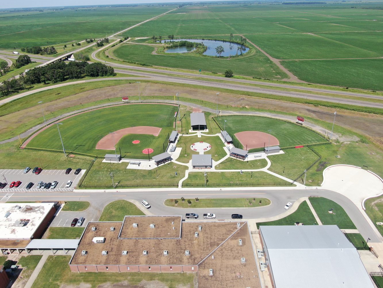 An aerial view of a baseball field and a school.