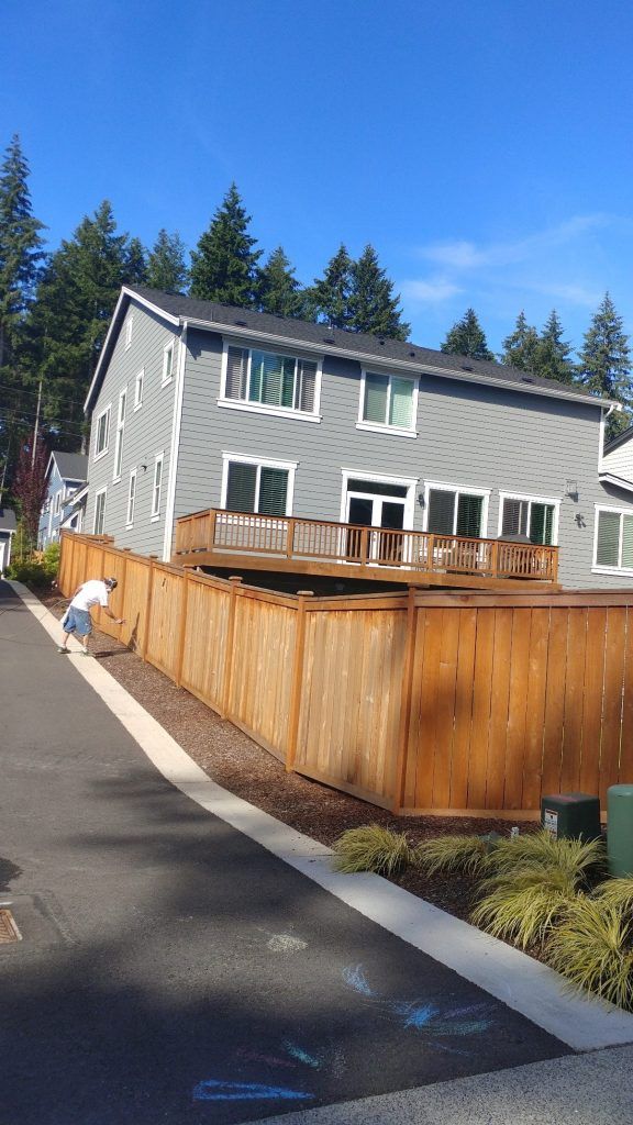 Man Painting The Fence — Seattle, WA — Cordeck Painting Services LLC