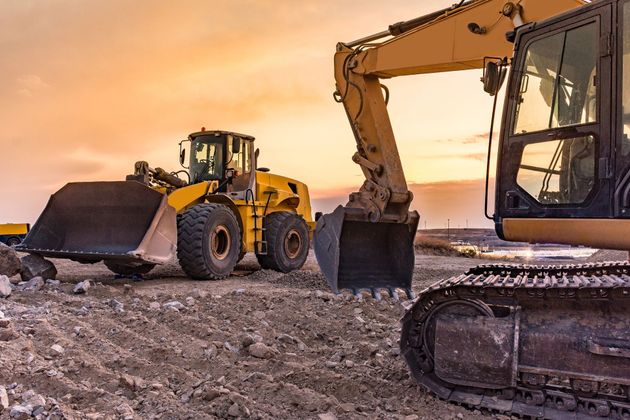 A bulldozer and a wheel loader are working on a construction site.