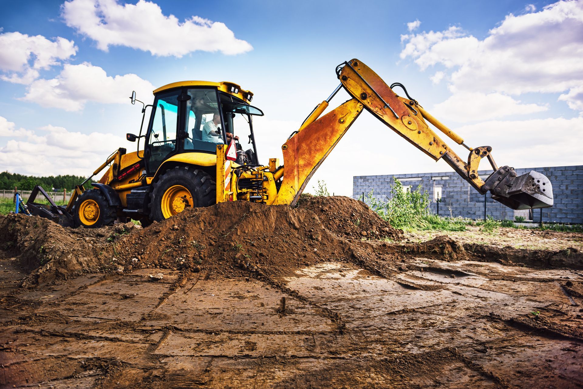 An excavator is working on land site preparation.