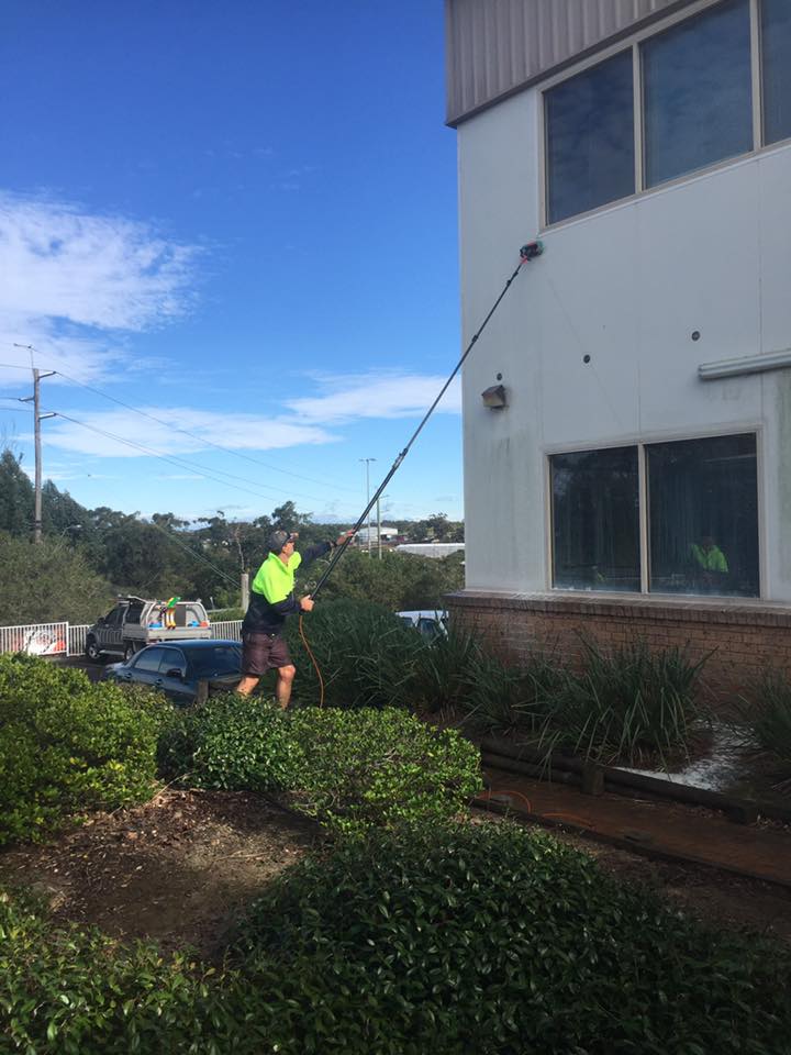Worker Cleaning Exterior Of A Building — Professional Cleaners In Central Coast, NSW