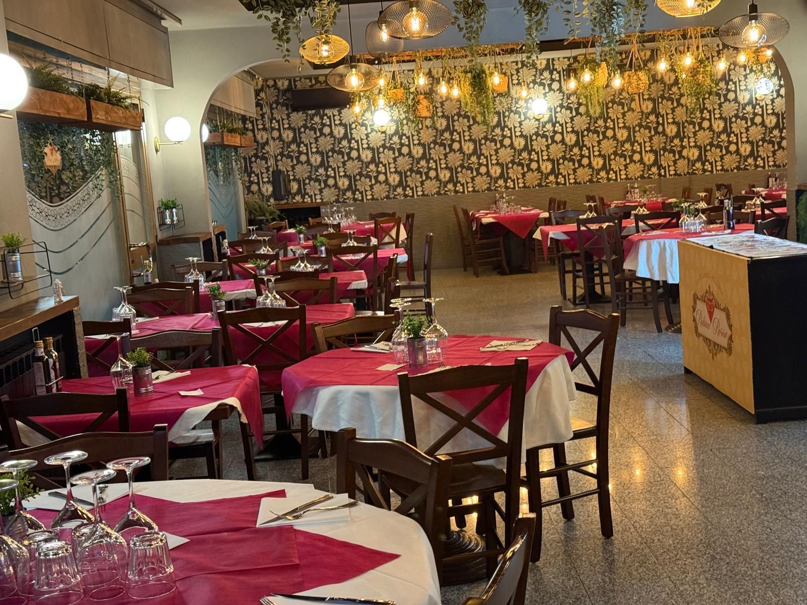 Una grande sala da pranzo con tavoli e sedie e un lampadario