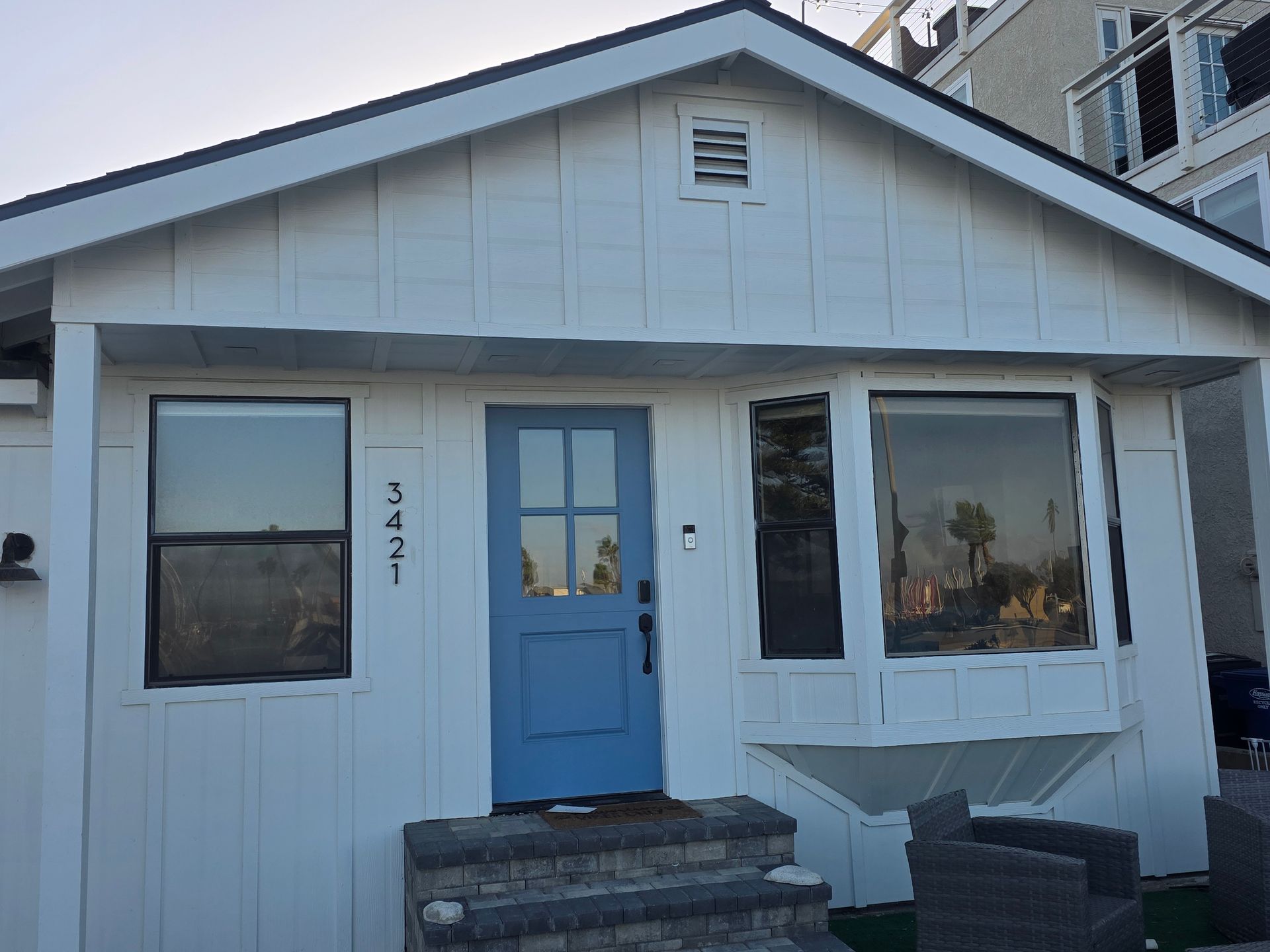 A person is loading plates and silverware into a dishwasher.
