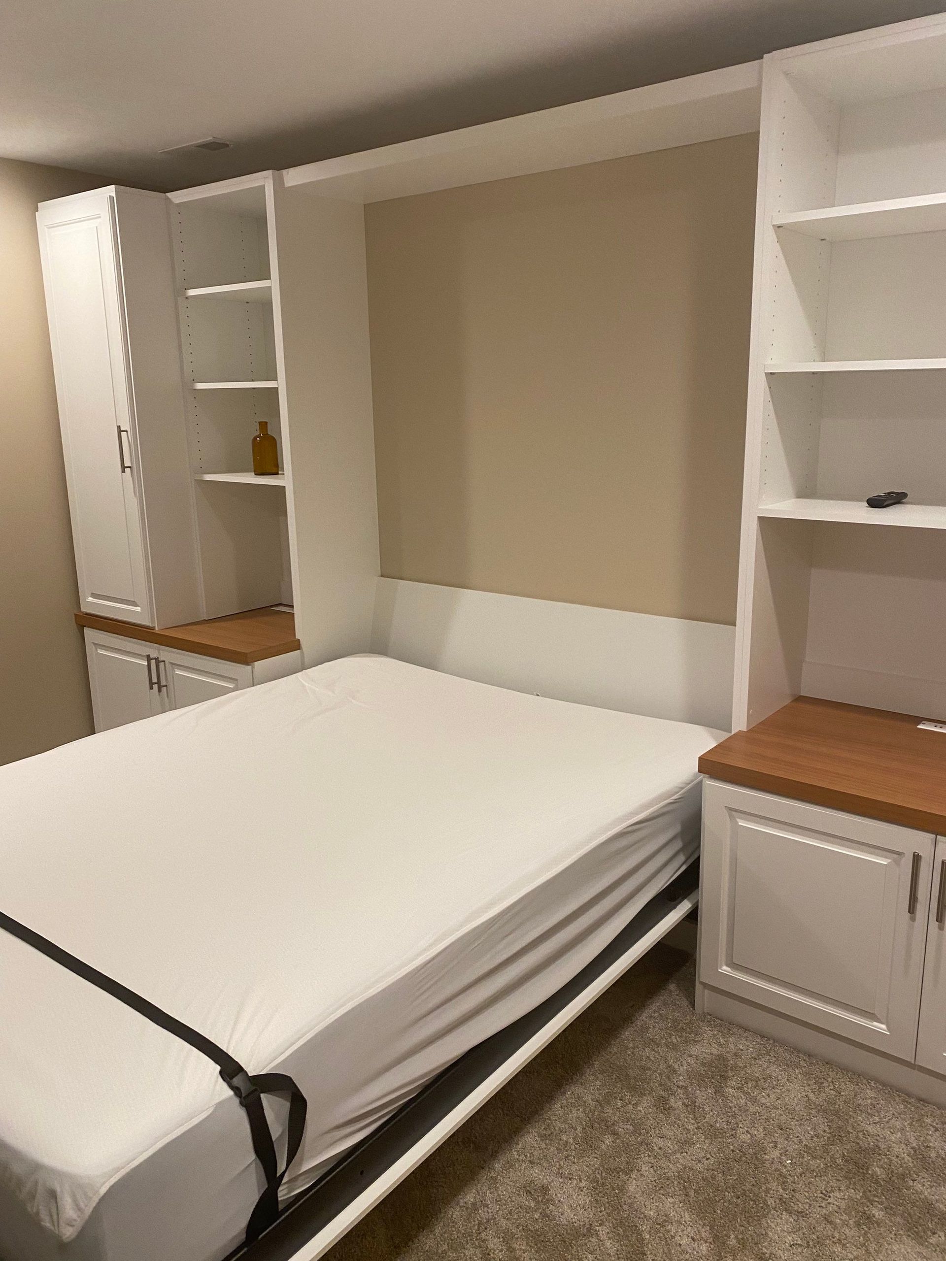 Custom Murphy bed installation showcasing a space-saving wall bed with built-in cabinetry.