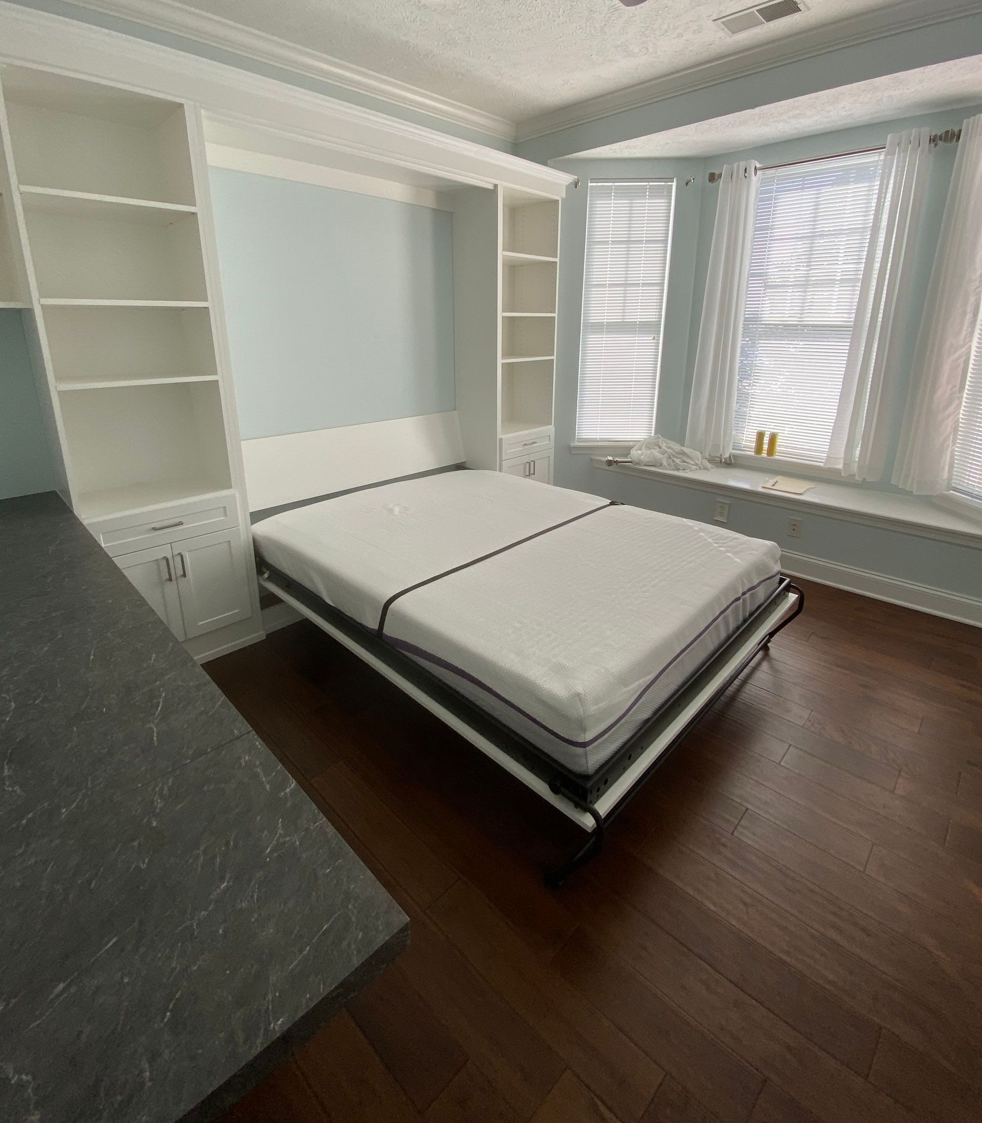 Murphy bed in a home office creating a space-saving guest room with a fold-down wall bed.