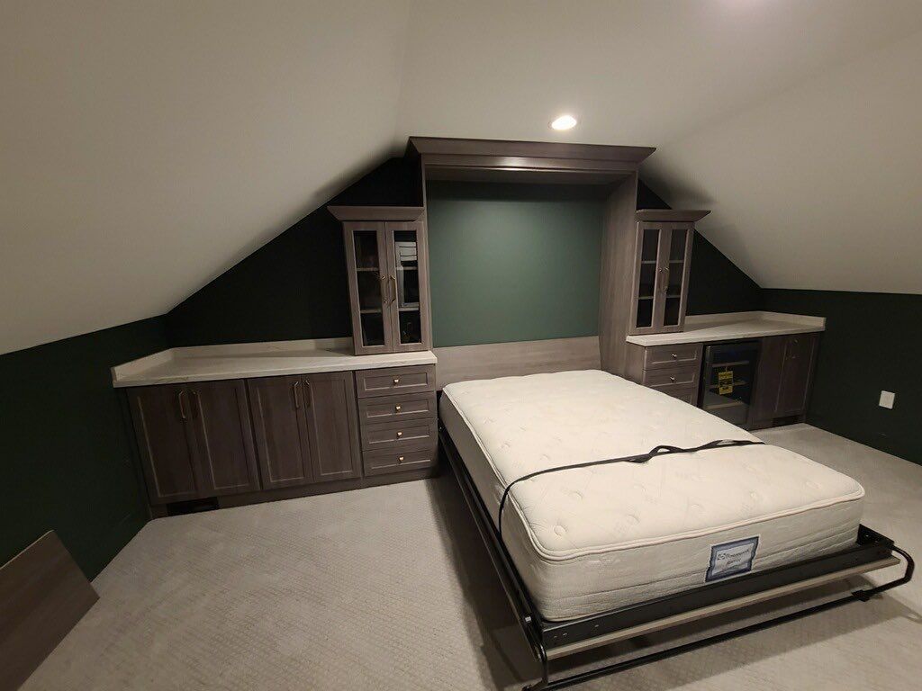 Murphy bed in a bonus room creating a flexible guest space with a fold-down wall bed