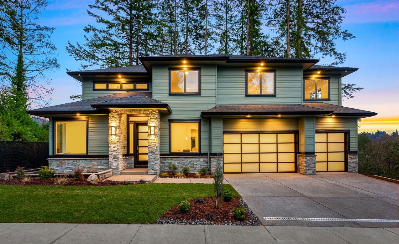 A large house with a lot of windows and a garage door.