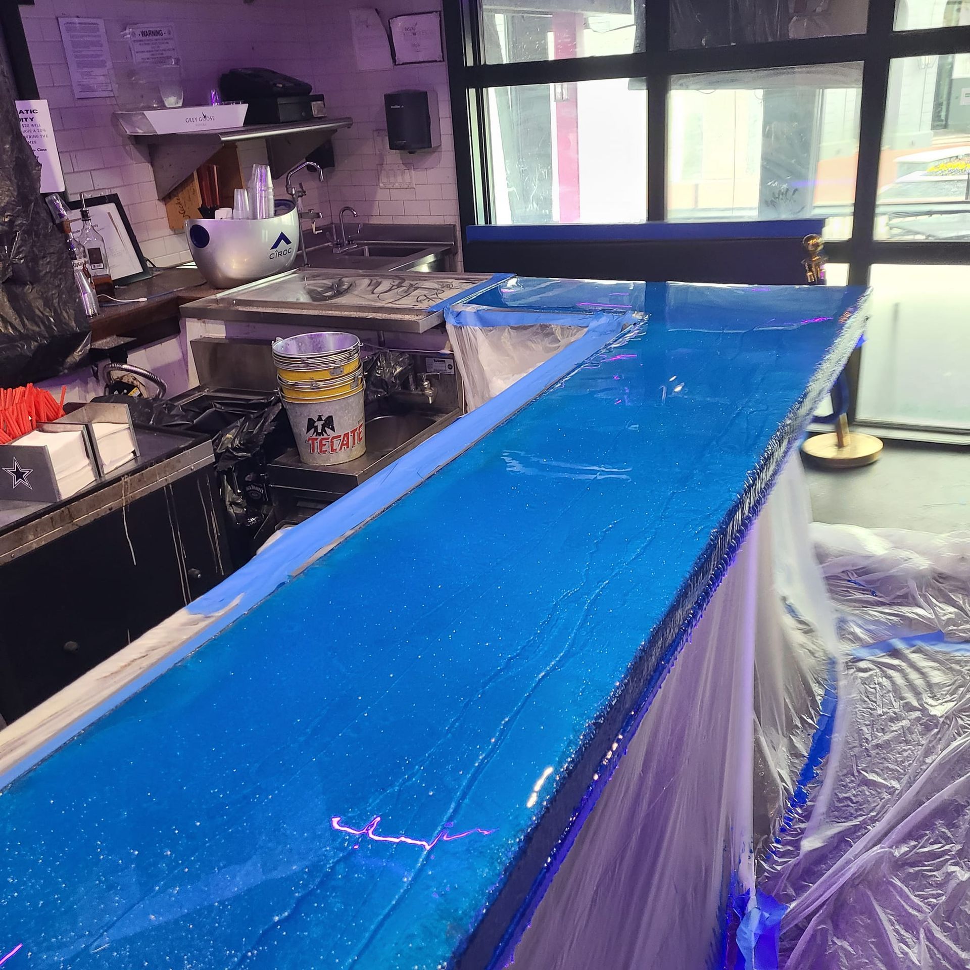 Blue glitter epoxy bar being finished; inside a bar.