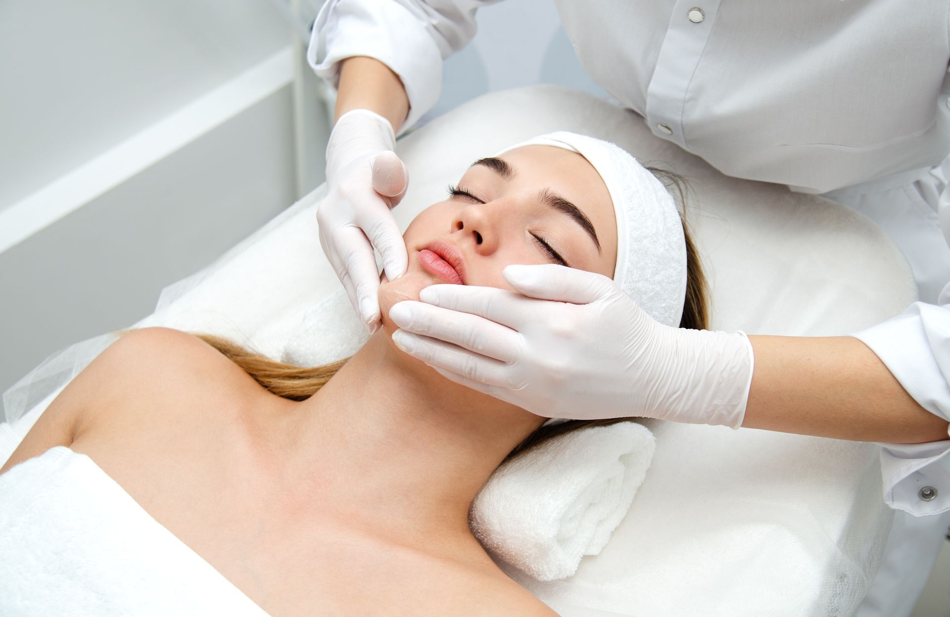 A woman getting a facial beauty treatment in a medical spa center