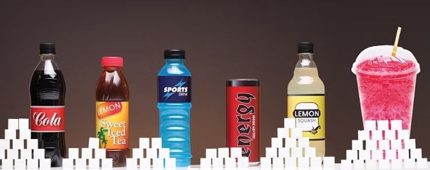 Various sugary drinks lined up on sugar cubes.