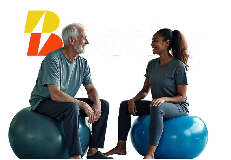 A man and a woman are sitting on exercise balls and talking.