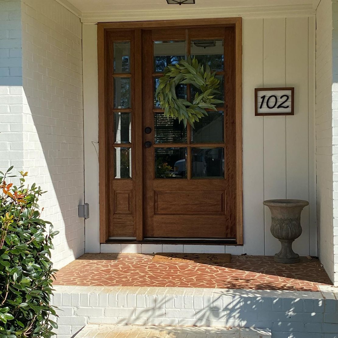 The front door of a house with the number 102 on it in Carrollton Ga