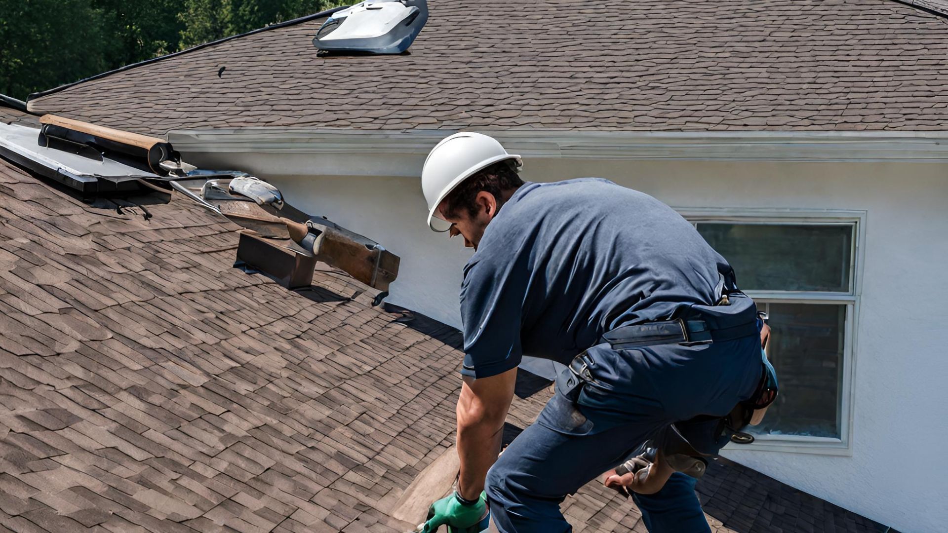 A man is working on the roof of a house in Carrollton Ga