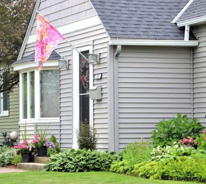 A house with a flag hanging from the side of it