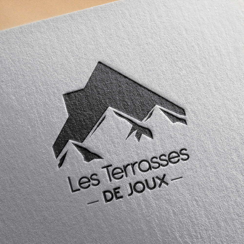 Un logo pour les terrasses de joux est sur un morceau de papier.
