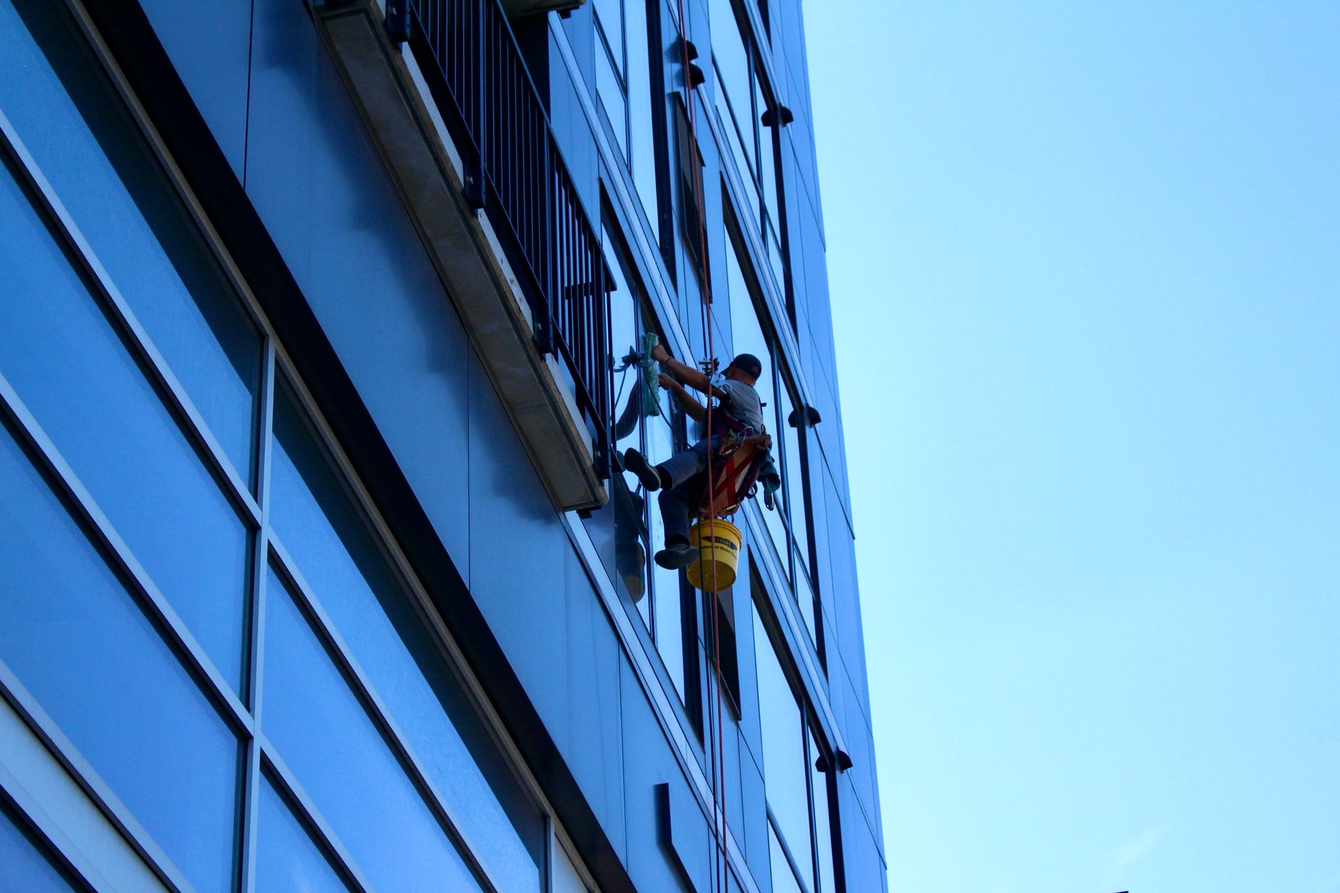 A man is climbing up the side of a building.