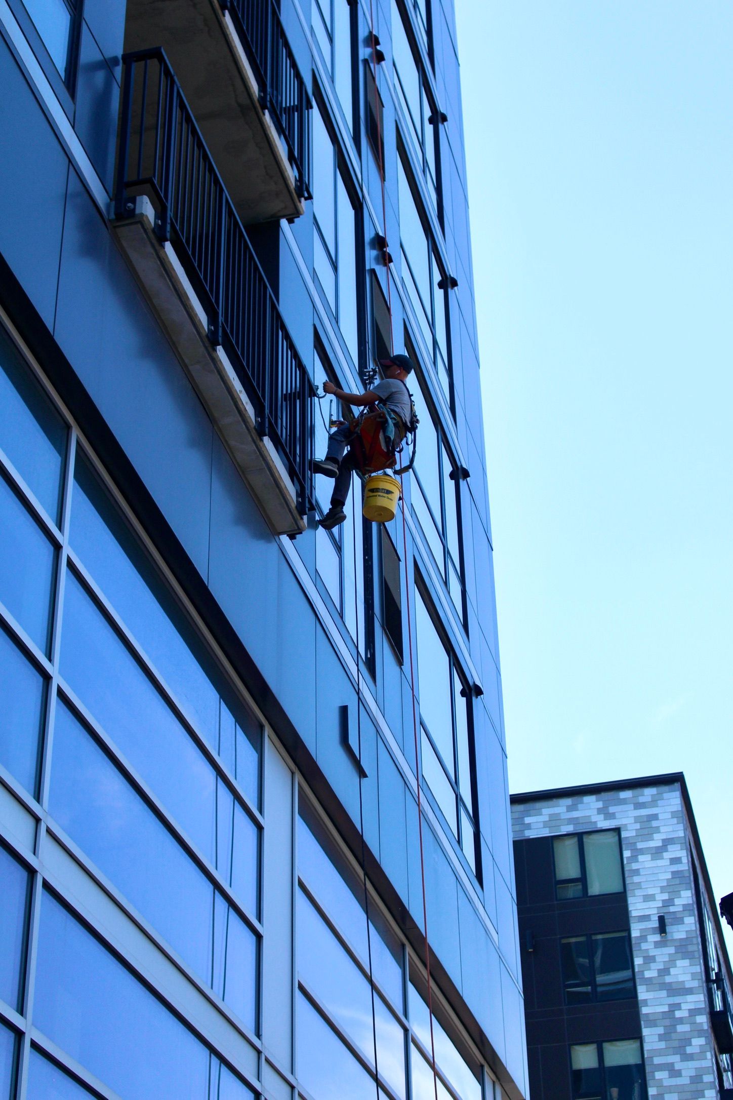 A man is climbing up the side of a building