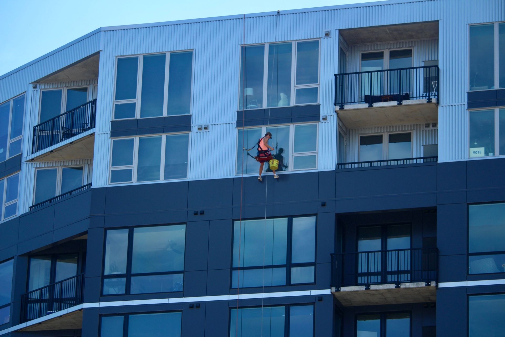 A man is climbing up the side of a building.
