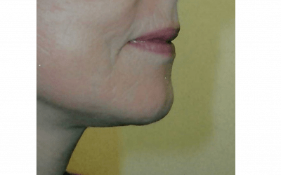 A close up of a woman 's face with a slight smile on her face.