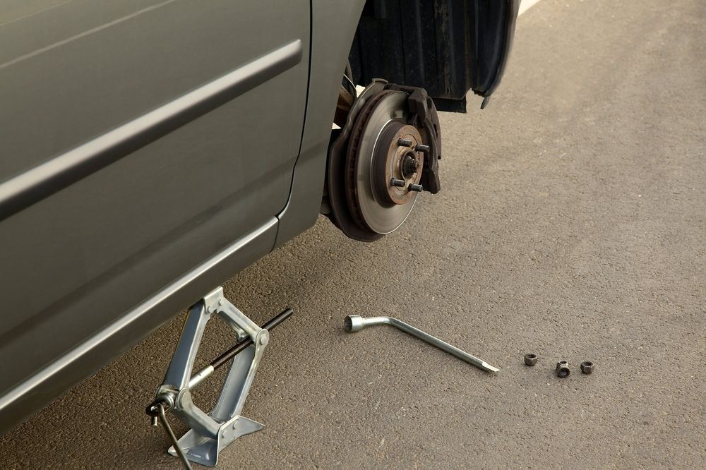 A Car With a Broken Wheel is Being Repaired With a Jack — Stamford Tyres In Ballarat Central, VIC