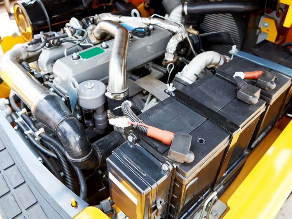 A Close Up of a Yellow Forklift Engine With Batteries — Stamford Tyres In Ballarat Central, VIC