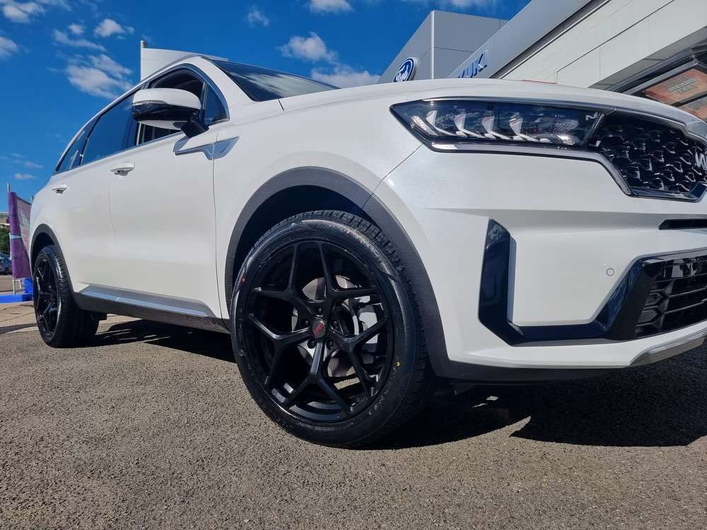 A White Suv With Black Wheels is Parked in Front of a Building — Stamford Tyres In Ballarat Central, VIC
