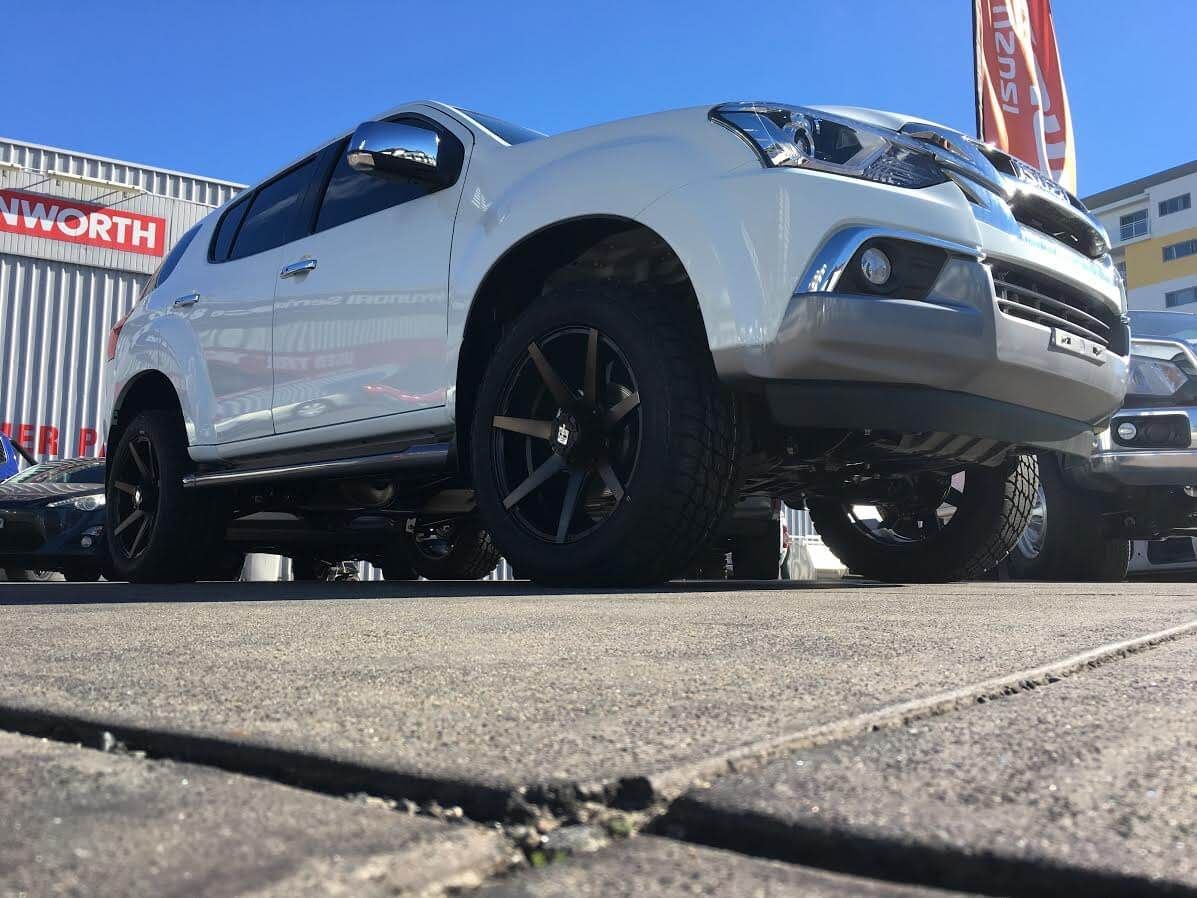 A White Suv is Parked on the Side of the Road in Front of a Building — Stamford Tyres In Ballarat Central, VIC