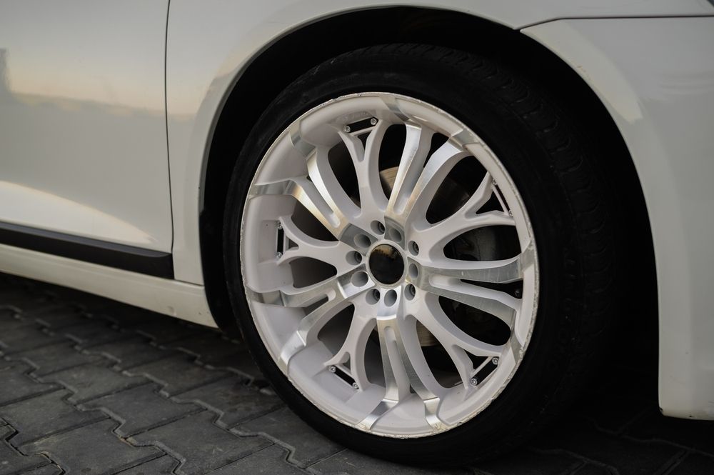 A Close Up of a White Car Wheel on a Brick Road — Stamford Tyres In Ballarat Central, VIC