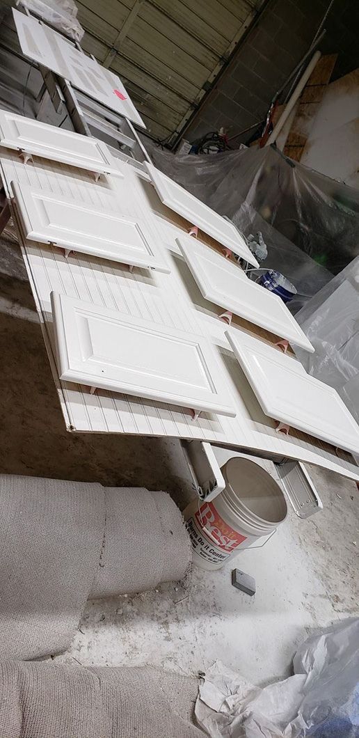 A bunch of white notebooks are sitting on top of a table.