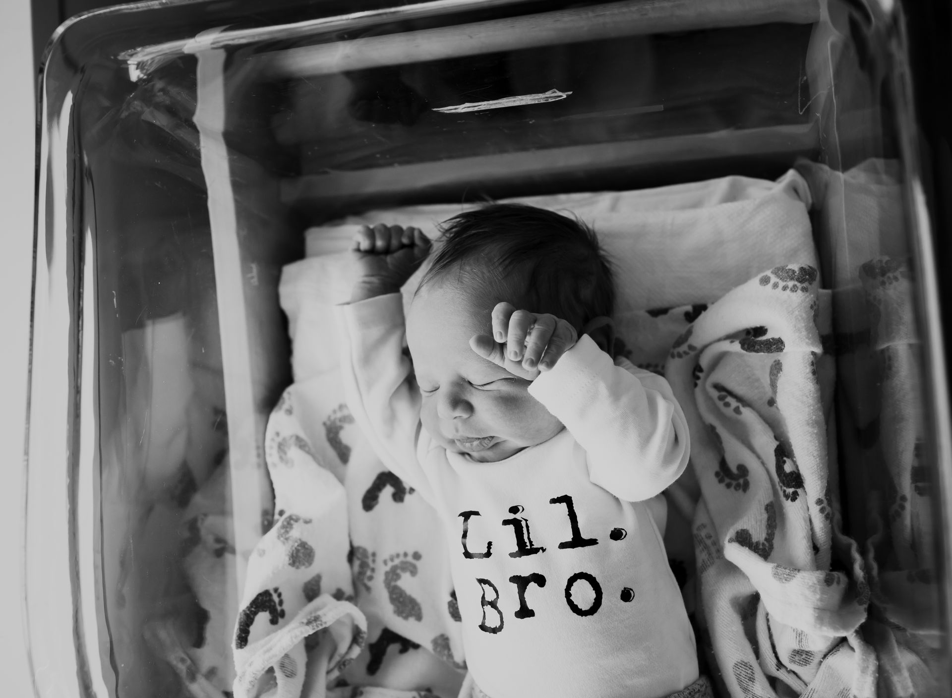 Baby in a hospital bassinet, wearing a