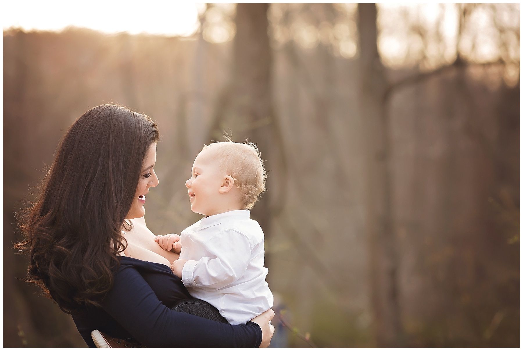 A woman is holding a baby in her arms.