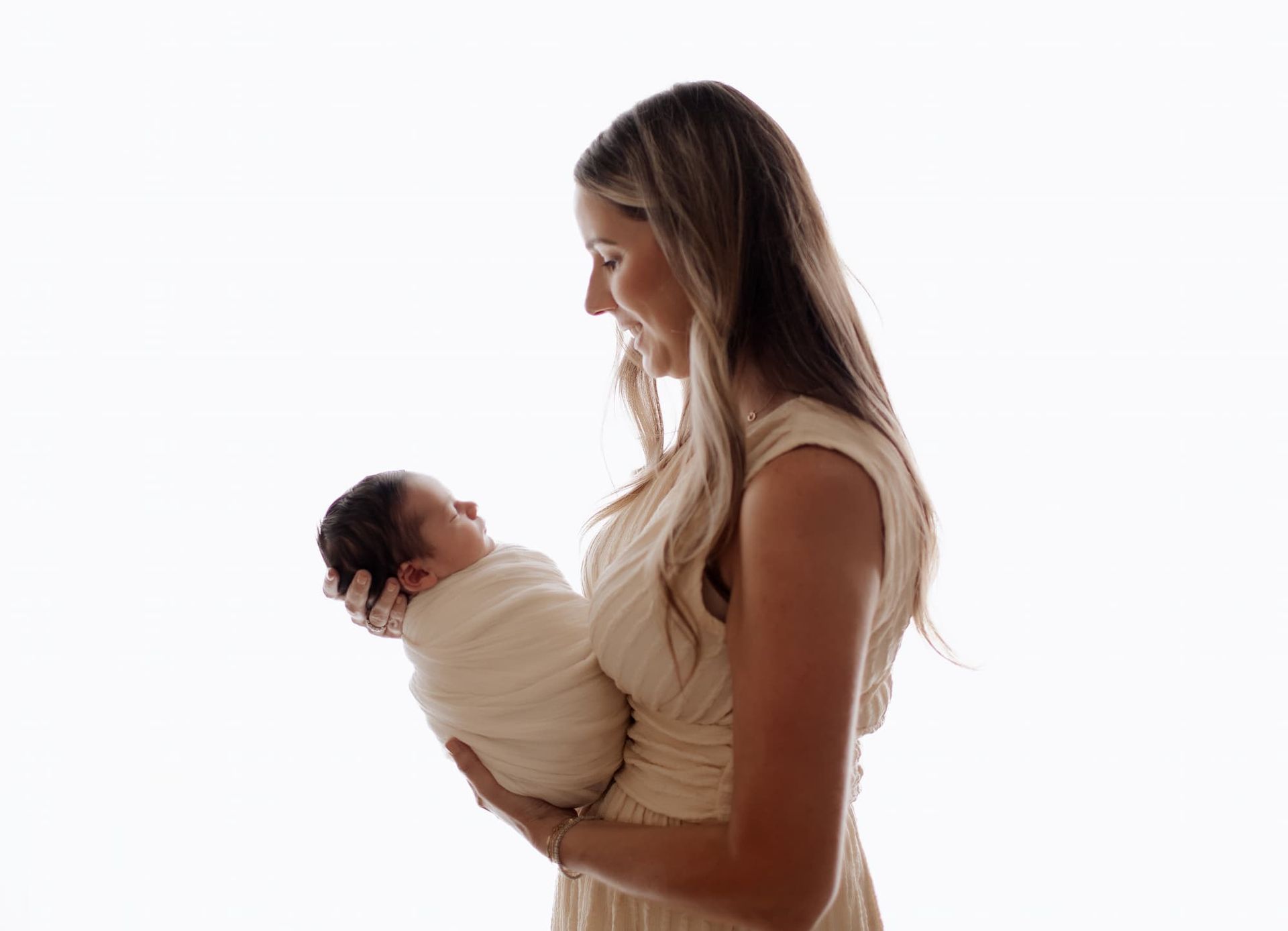 mother holding her newborn baby during a Bergen County NJ newborn photography session