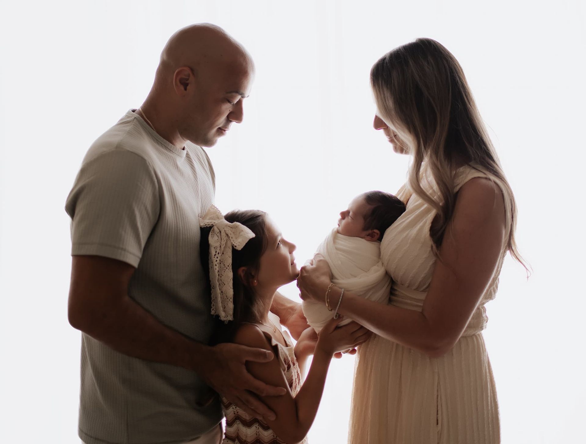 parents with newborn baby and big sister during a Bergen County NJ newborn photography session