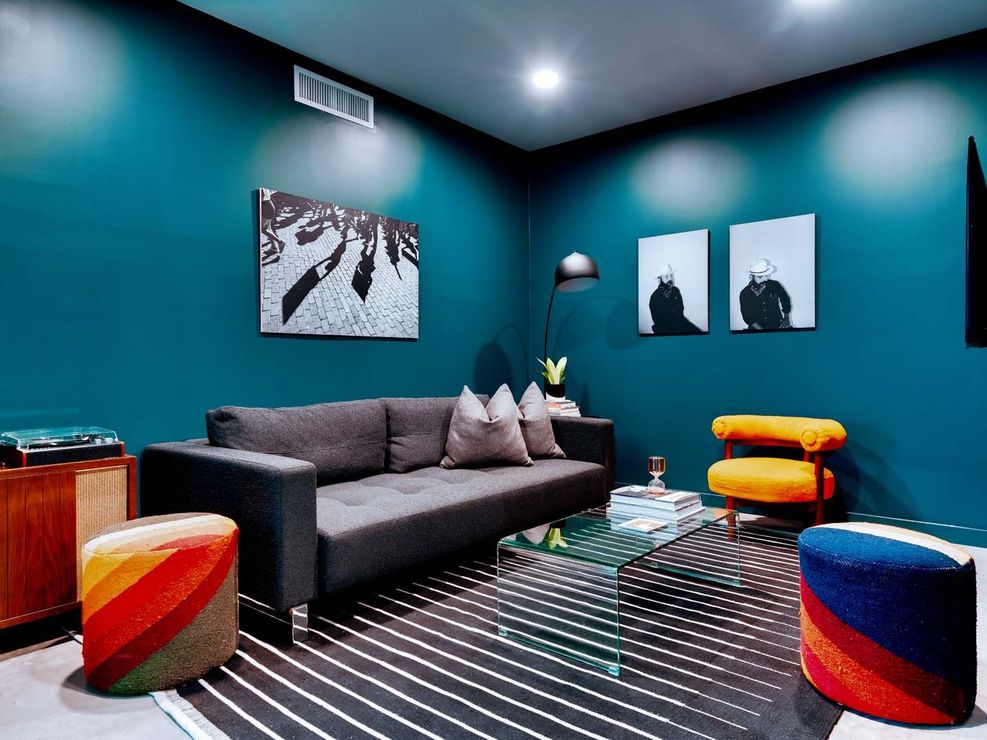 A living room with blue walls and a couch