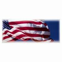 American flag waving against a blue sky.