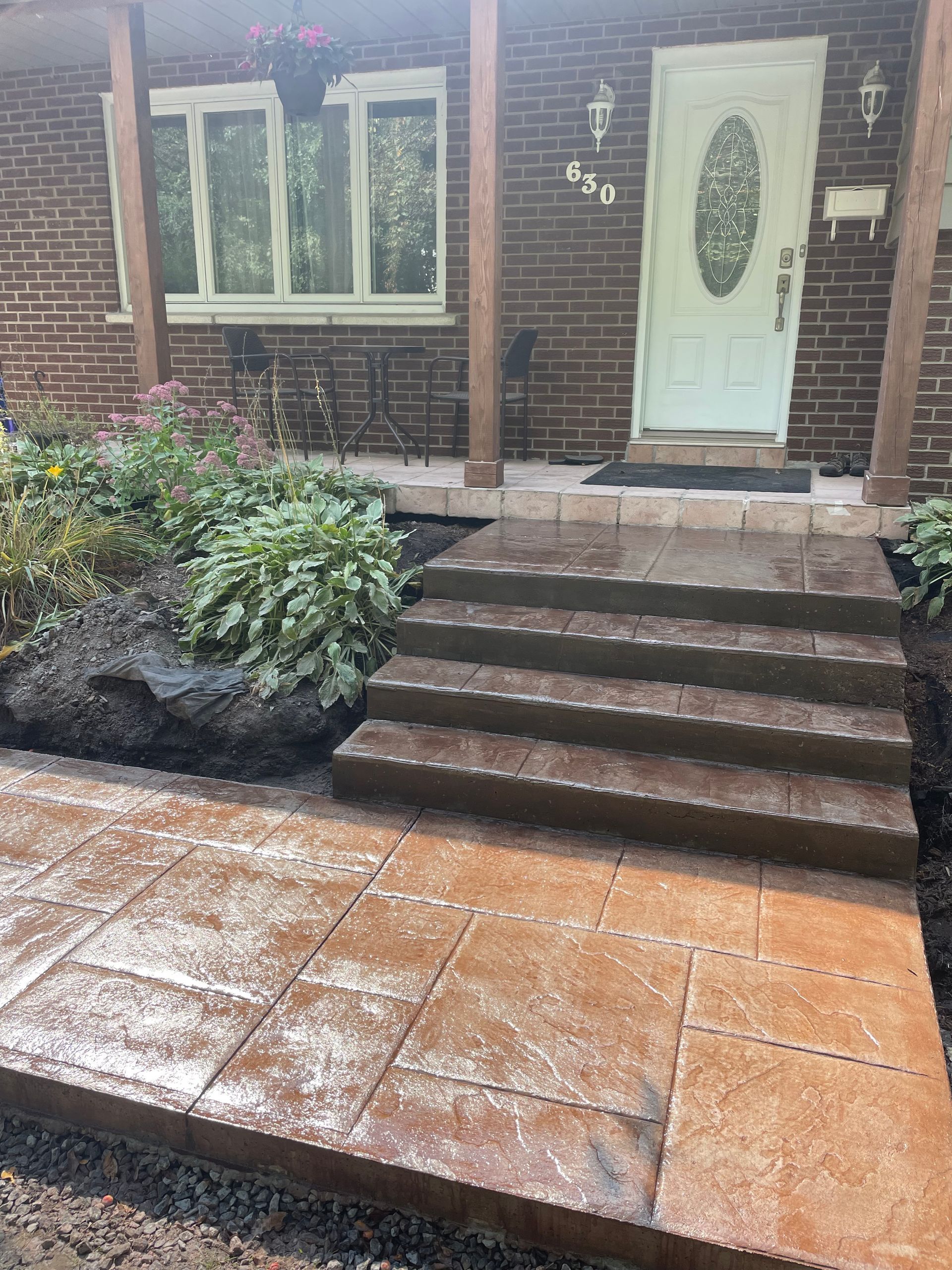 Une maison en briques avec des marches menant à la porte d'entrée.