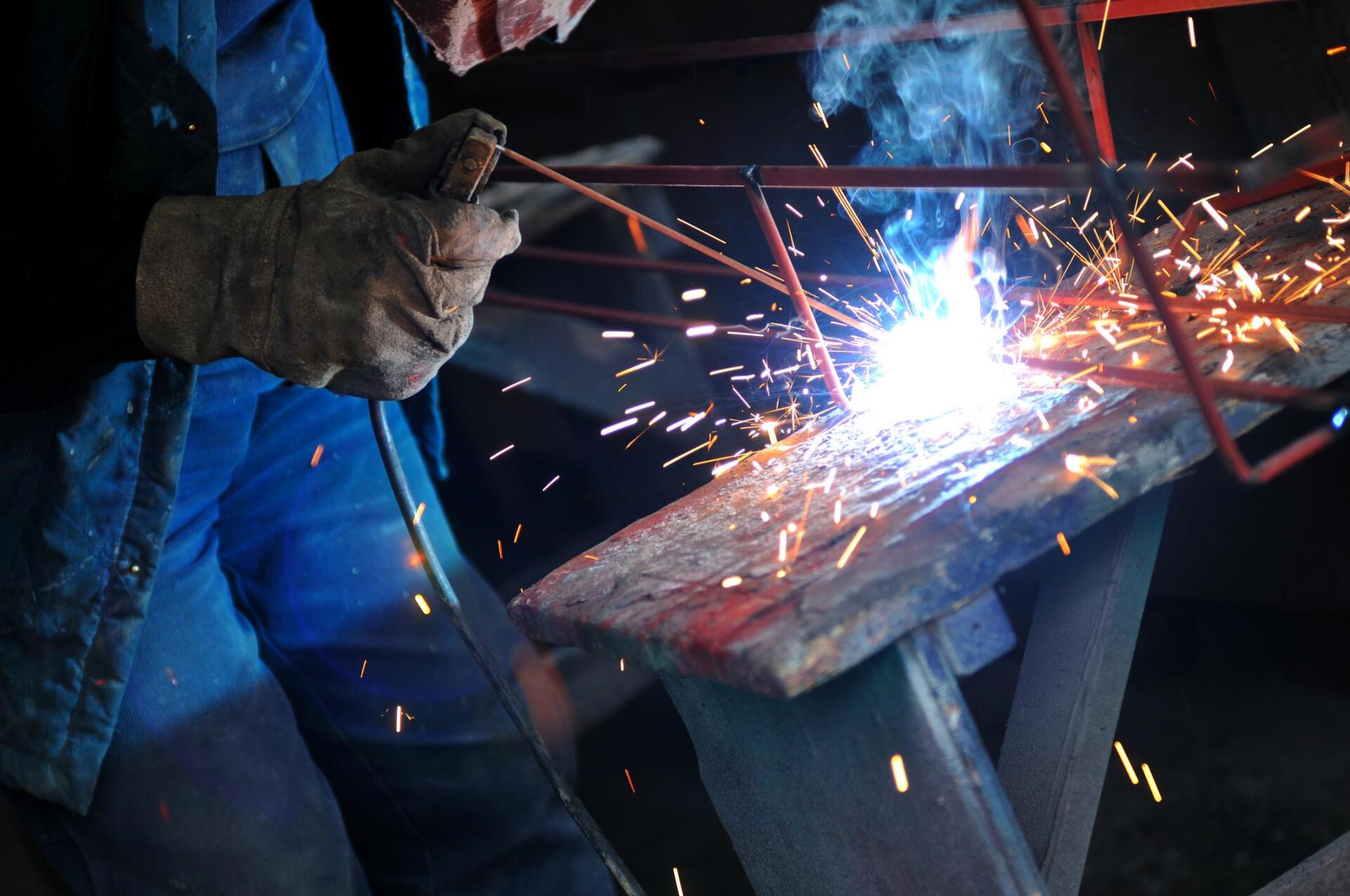 worker using a welding machine