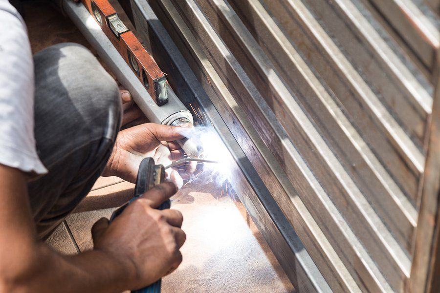 man using a welding machine in the metal