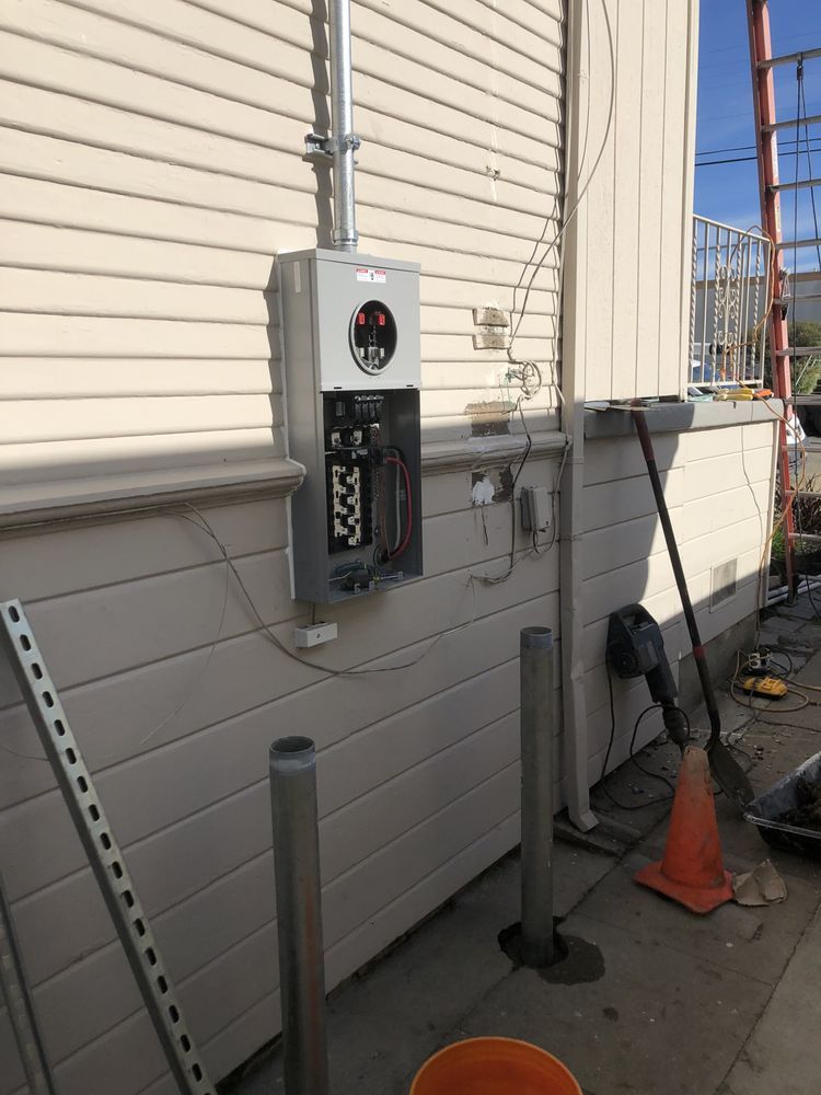 Nighttime garden scene illuminated by small pathway lights, showcasing lush greenery.