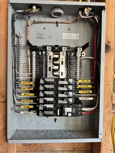 Silver electric SUV plugged into charging station.