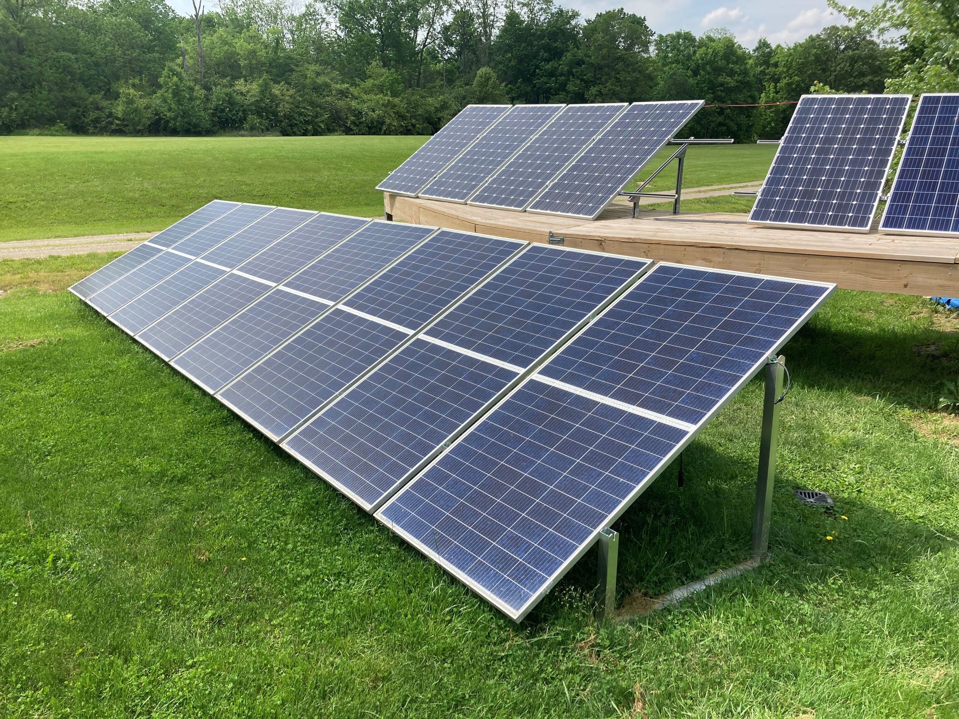 Solar panel installer on a roof in bright sunlight.