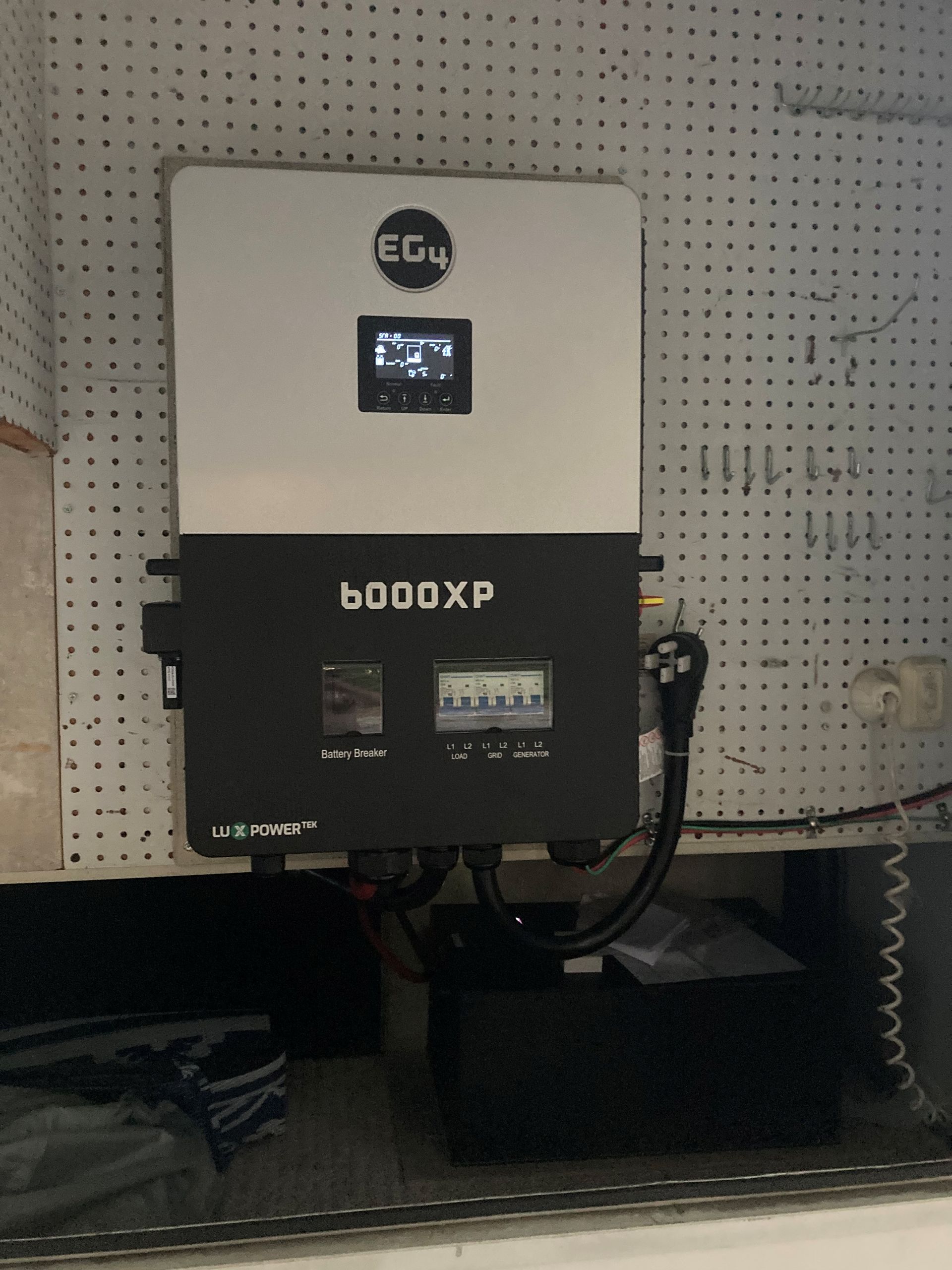Woman looks out window on a roof with solar panels.