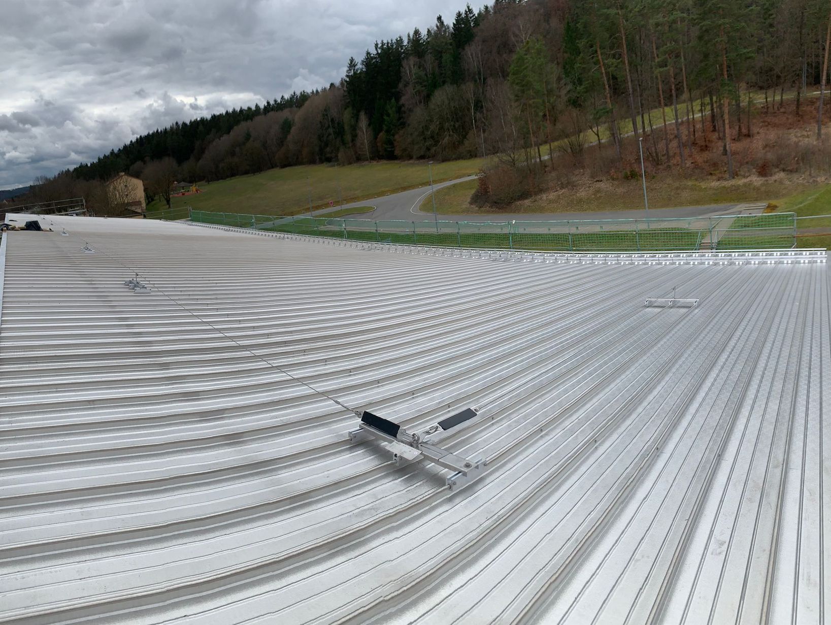 The roof of a building with trees in the background