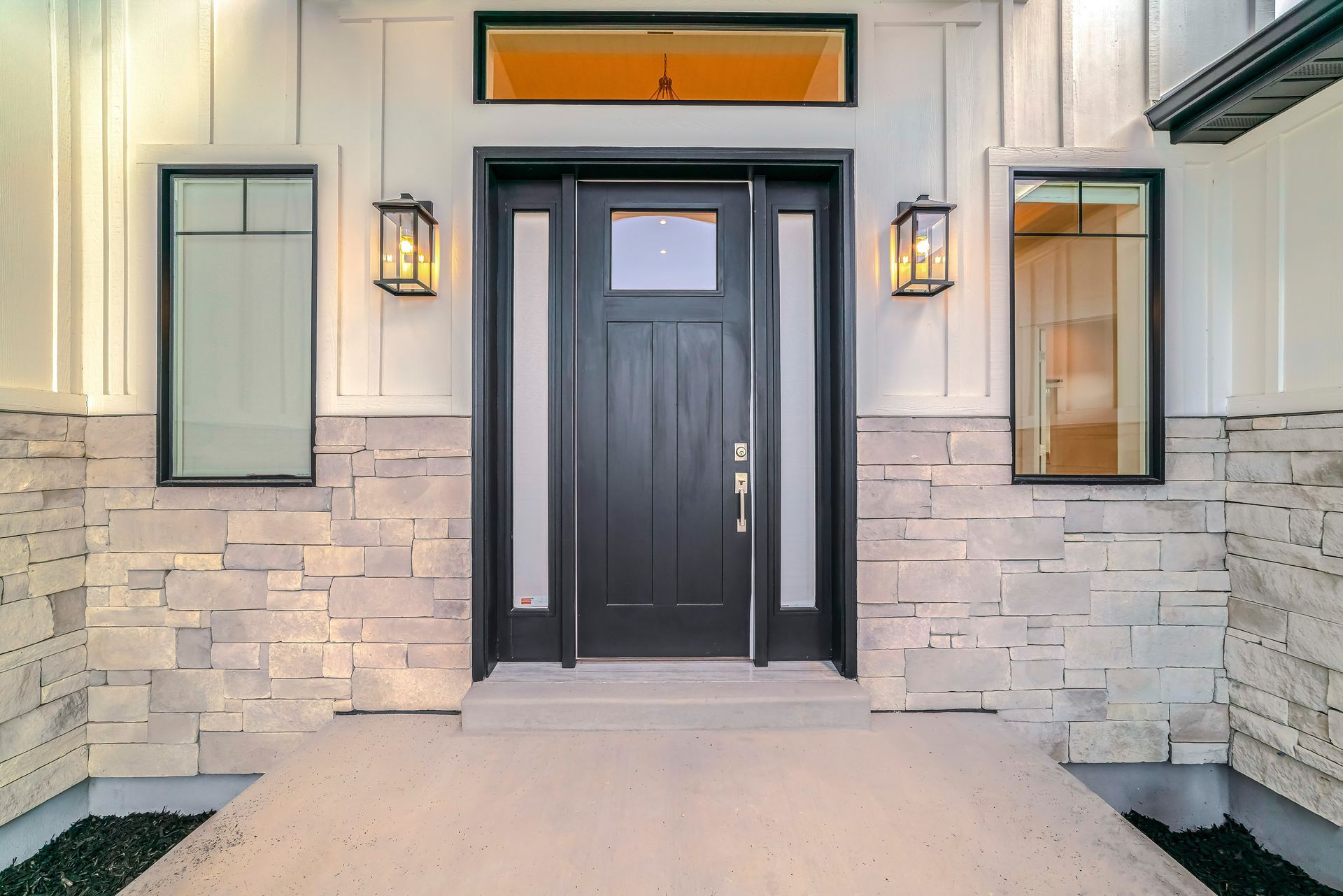 A black front door with two sidelights