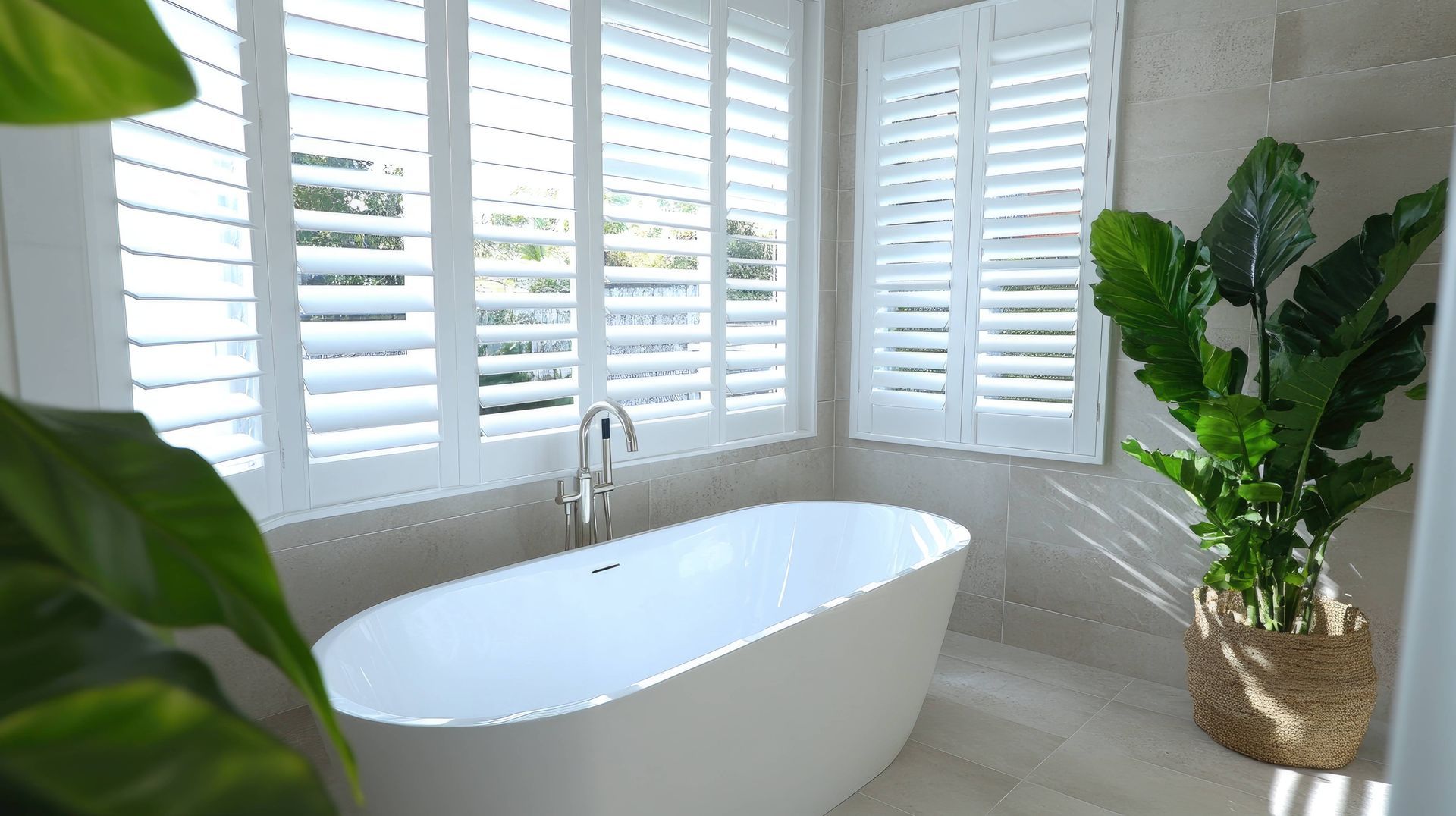 A luxury bathroom with elegant interior window shutters at Accent Blinds near Lexington and Chapin,
