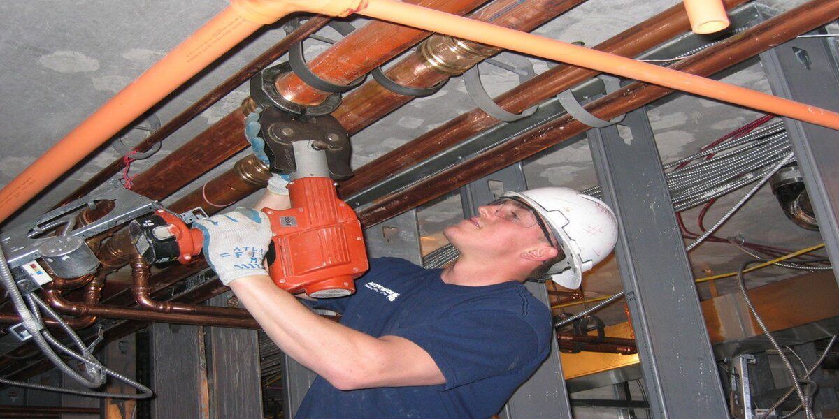 plumber working on commercial plumbing