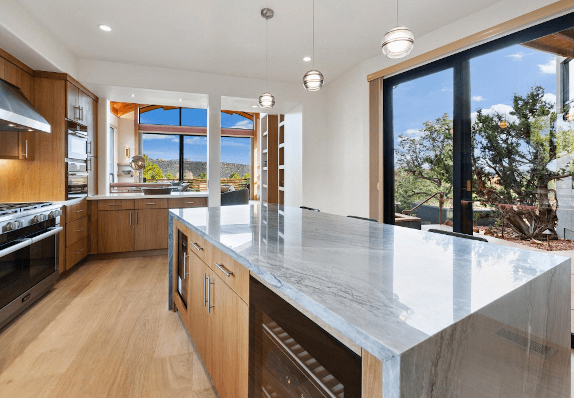A kitchen with a large island and a large window.